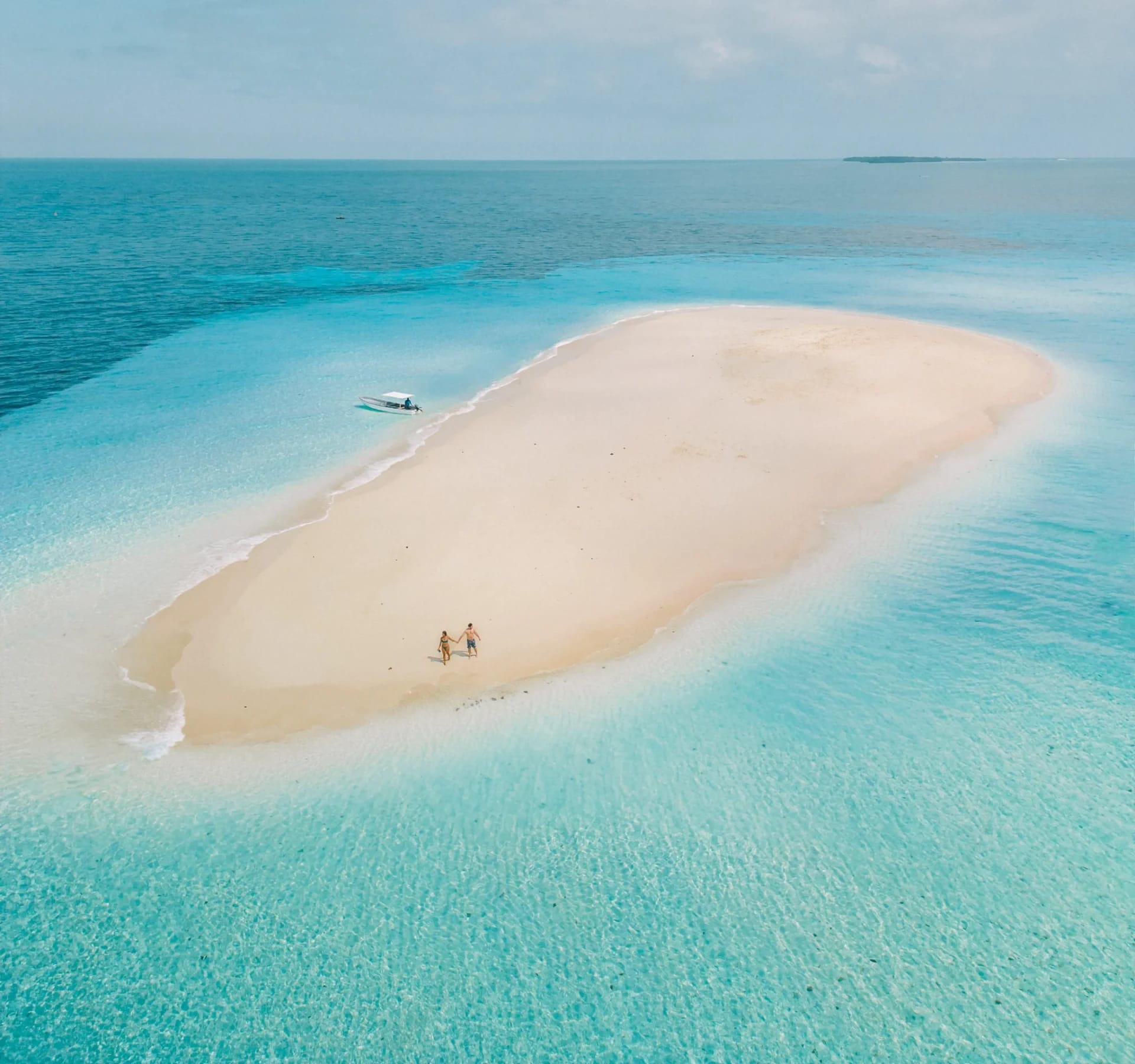 Aerial view of a white sand sandbank surrounded by turquoise Indian Ocean waters off the coast of Zanzibar