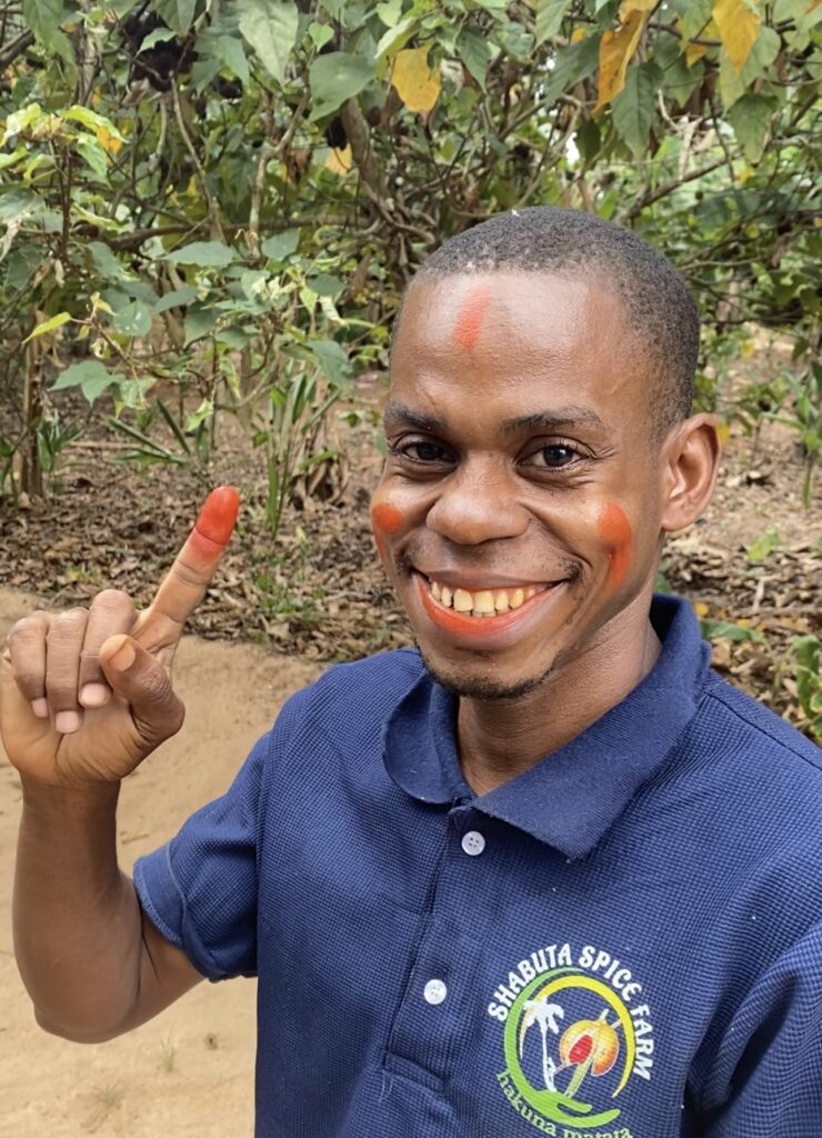 a man using organic food coloring on his face